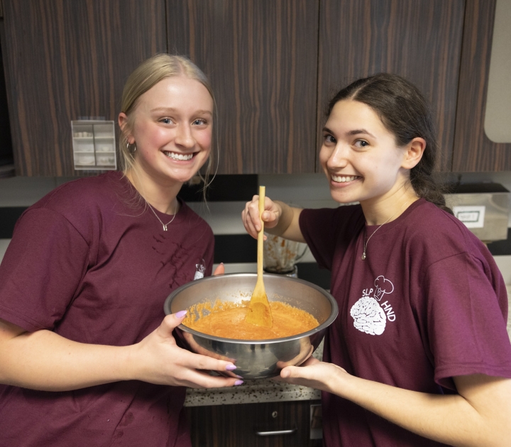 Two female student cooking