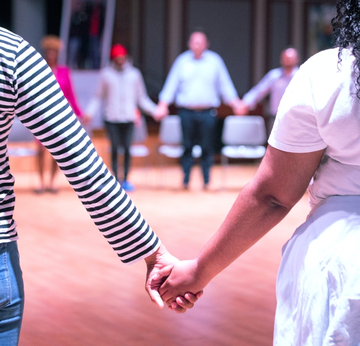 Students holding hands in a circle