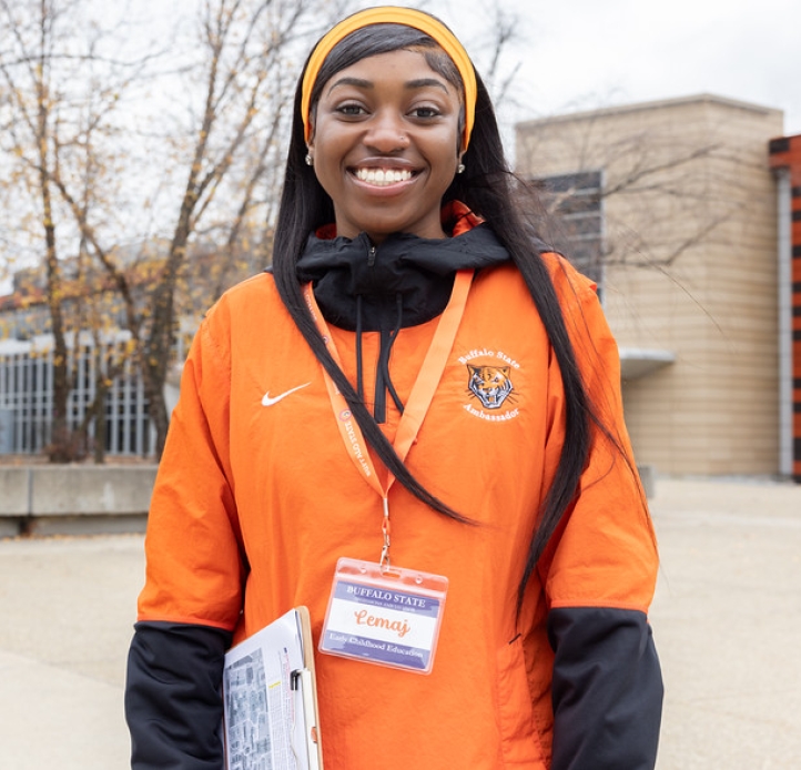 Smiling student holding a clipboard