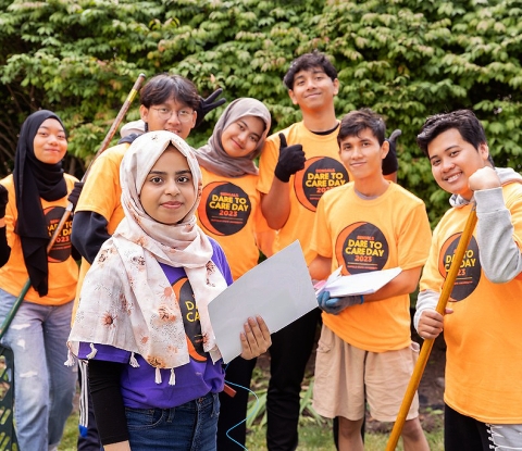 Group of students outside with rakes