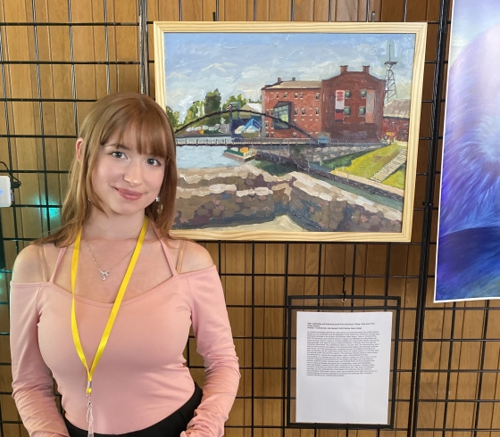 Julie Benhoff in front of oil painting presentation